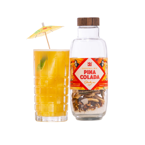 Pina Colada bottle with a glass of yellow cocktail on a white background