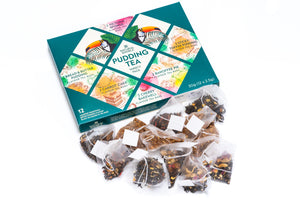 Pudding tea box with assorted pudding tea bags laid out on a white background
