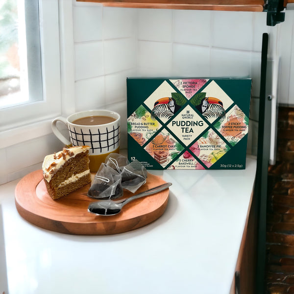 Pudding Tea made and Cake in Kitchen on round wooden platter in a white tiled kitchen corner