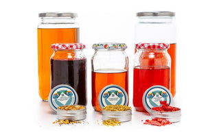  Natural & Noble Syrup Bases in Jars, with Hibiscus, Elderflower and Strawberry & Basil Tins.