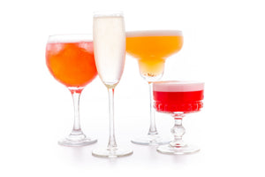 A selection of 4 gin drinks in various shaped glassware