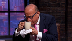 A man drinking Natural & Noble Chai on Television