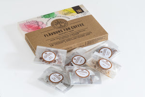 Box of coffee flavour packets with visible branding on a white background