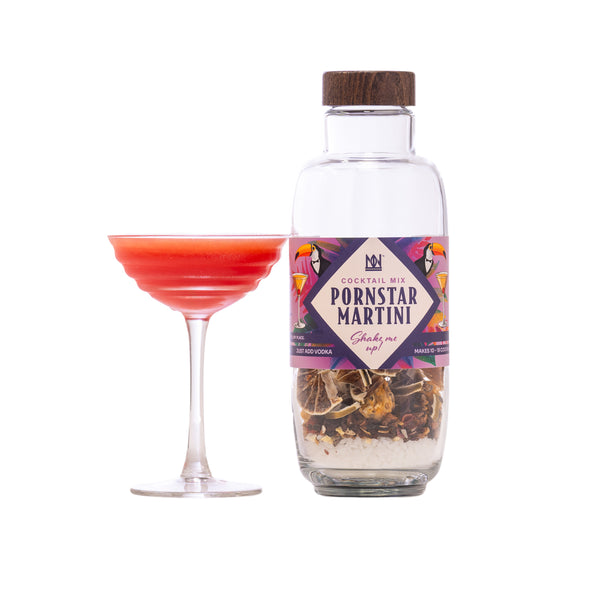 Bottle of 'Pornstar Martini' cocktail mix with a labeled glass of red cocktail on a white background