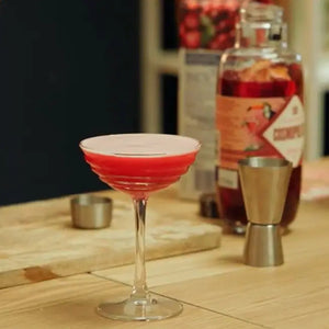 A Cosmopolitan Cocktail in a Coupe Glass Made from a Natural & Noble Cosmopolitan Cocktail Kit 
